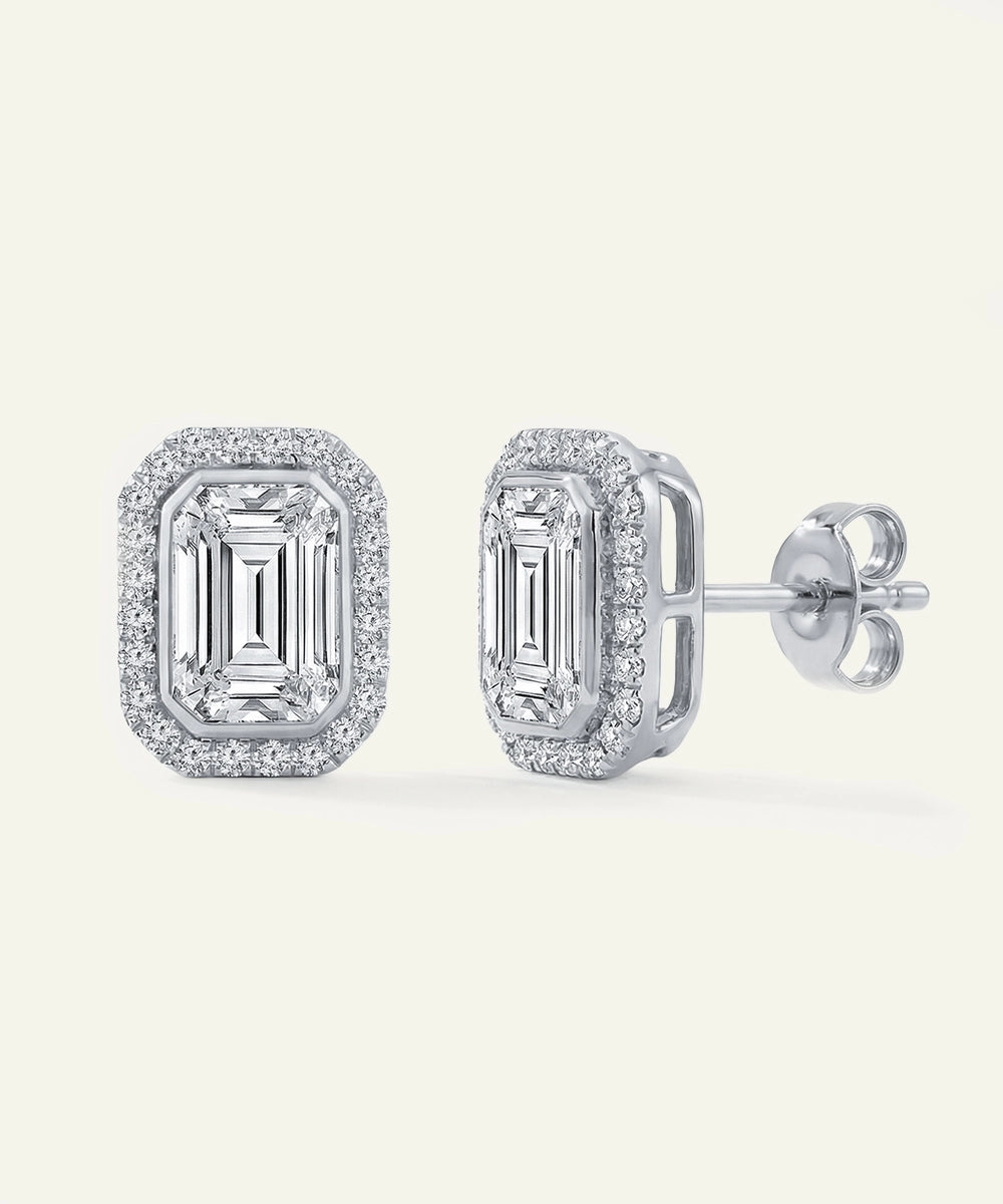 Pair of diamond earrings on a light gray background