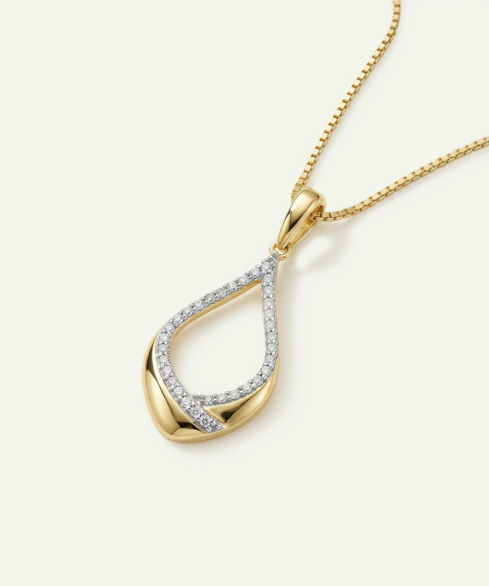 Gold necklace with a teardrop-shaped pendant on a white background