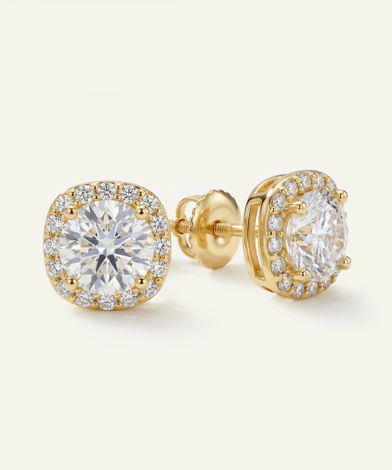 Gold earrings with clear gemstones on a white background