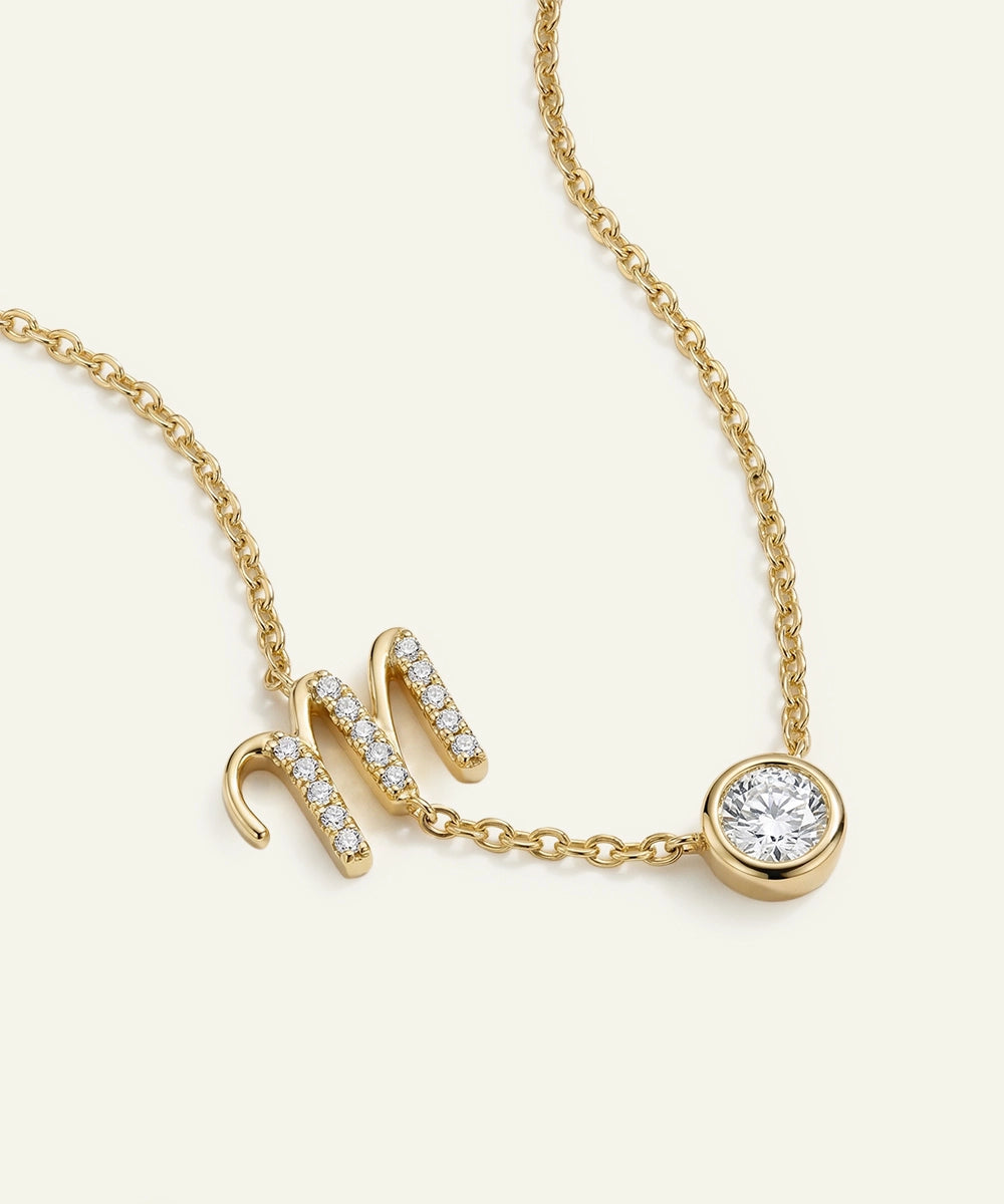 Gold necklace with diamond accents on a white background