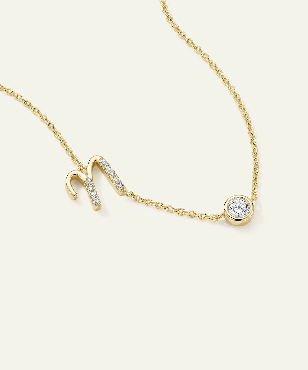 Gold necklace with a small diamond pendant on a white background