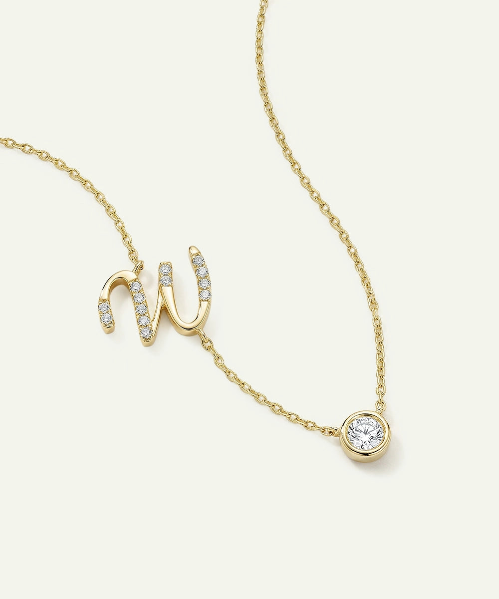 Gold necklace with a unique pendant design on a white background