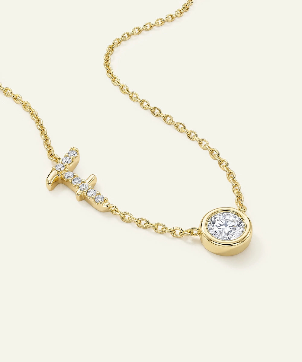 Gold necklace with a diamond pendant on a white background