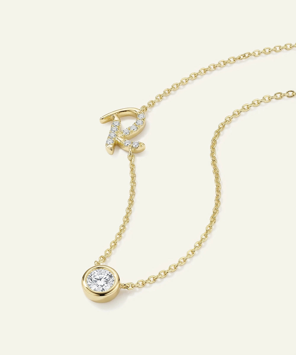 Gold necklace with a letter 'R' pendant on a white background