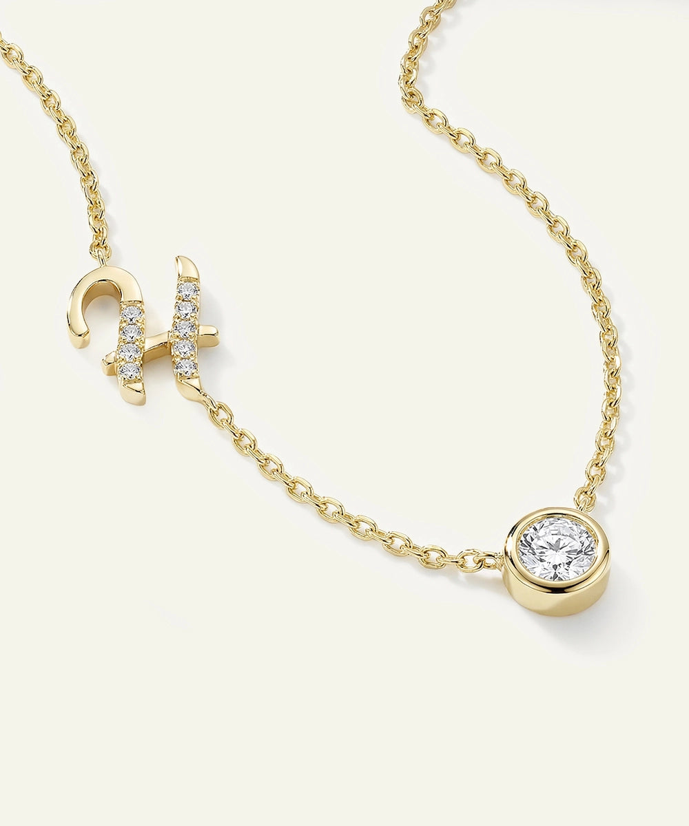 Gold necklace with a diamond pendant on a white background