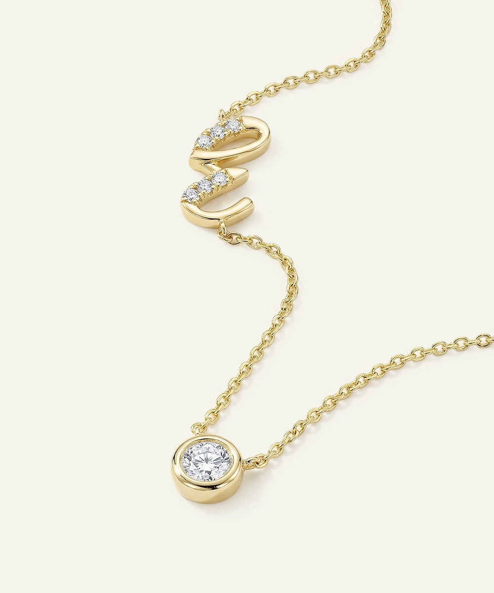 Gold necklace with diamond pendants on a light beige background