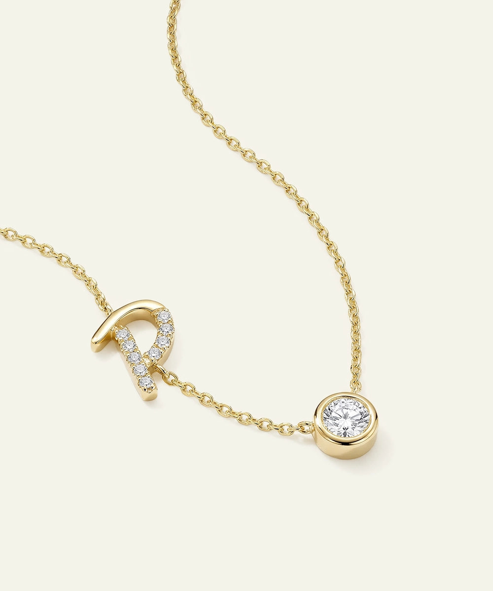 Gold necklace with a pendant on a light beige background