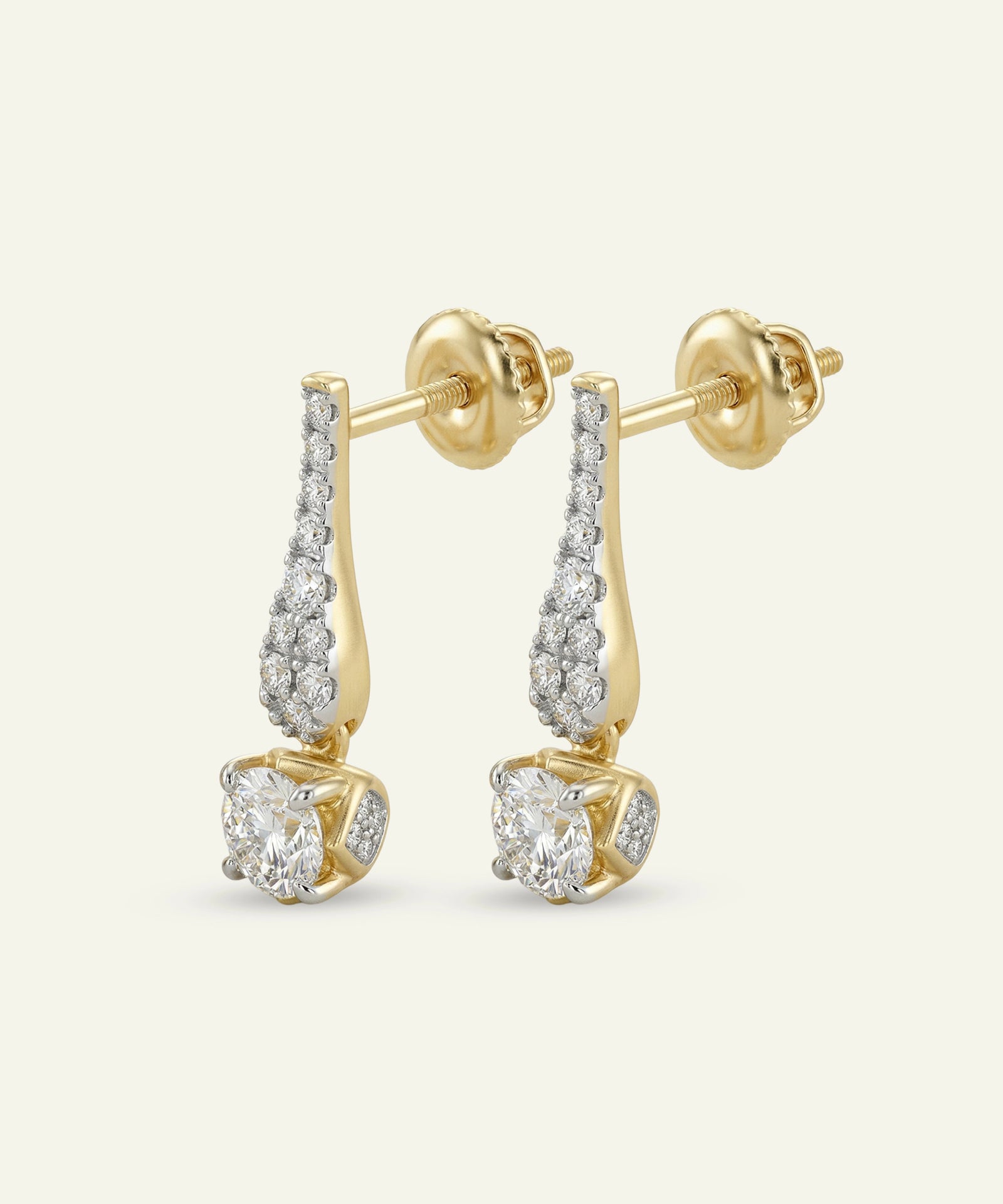 Gold earrings with diamond accents on a white background