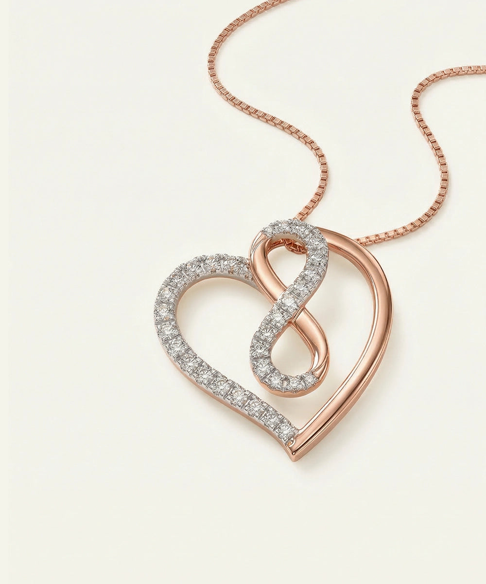 Rose gold and silver heart-shaped pendant necklace on a light background
