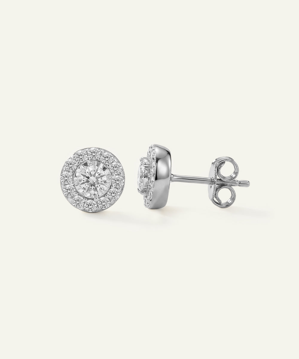 Pair of silver stud earrings on a white background