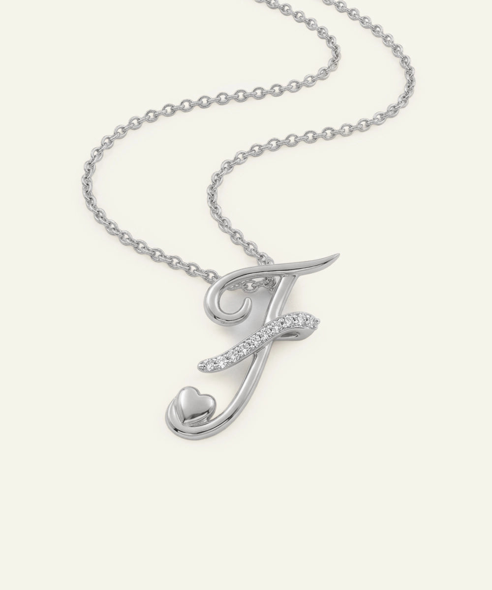 Silver necklace with a letter 'J' pendant on a white background