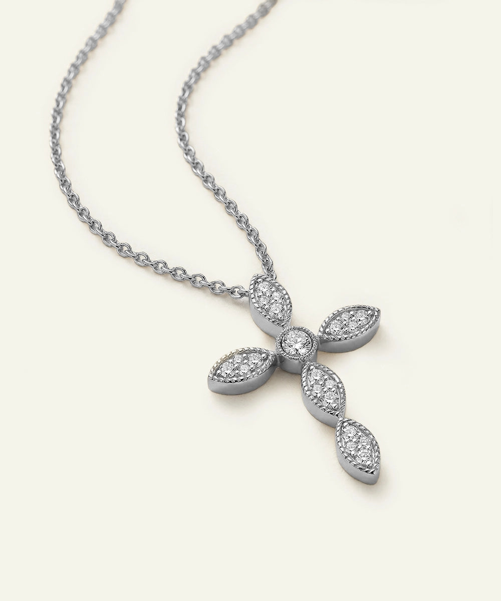 Silver necklace with a cross pendant on a light gray background