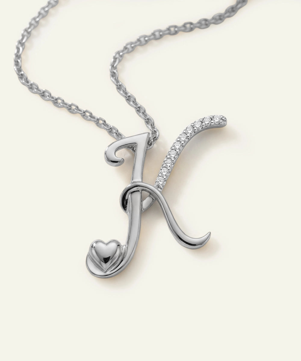 Silver necklace with a decorative pendant on a white background