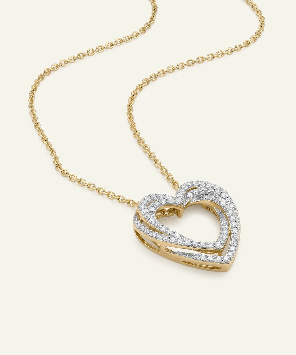 Gold heart-shaped necklace with diamonds on a white background