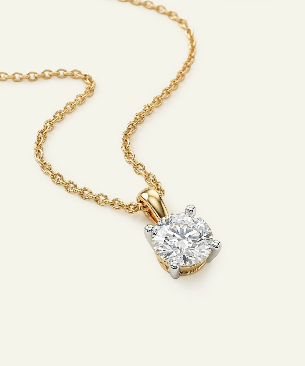 Gold necklace with a diamond pendant on a light background