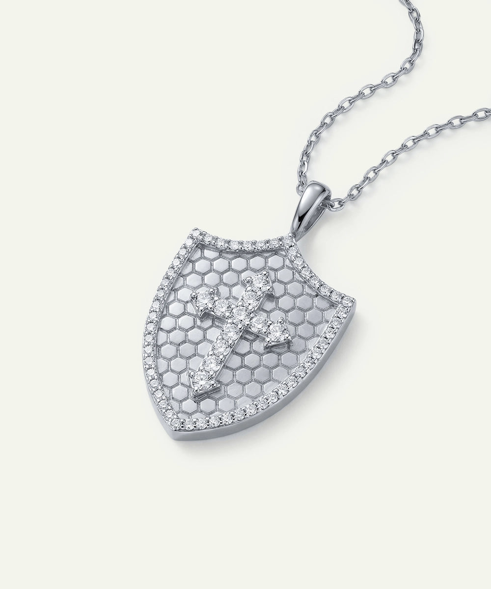 Silver necklace with a shield-shaped pendant on a light gray background