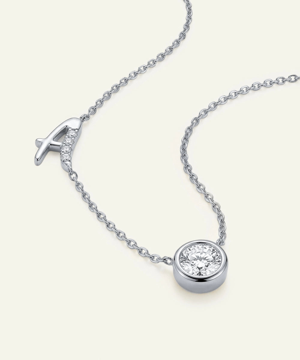 Silver necklace with a round diamond pendant on a white background