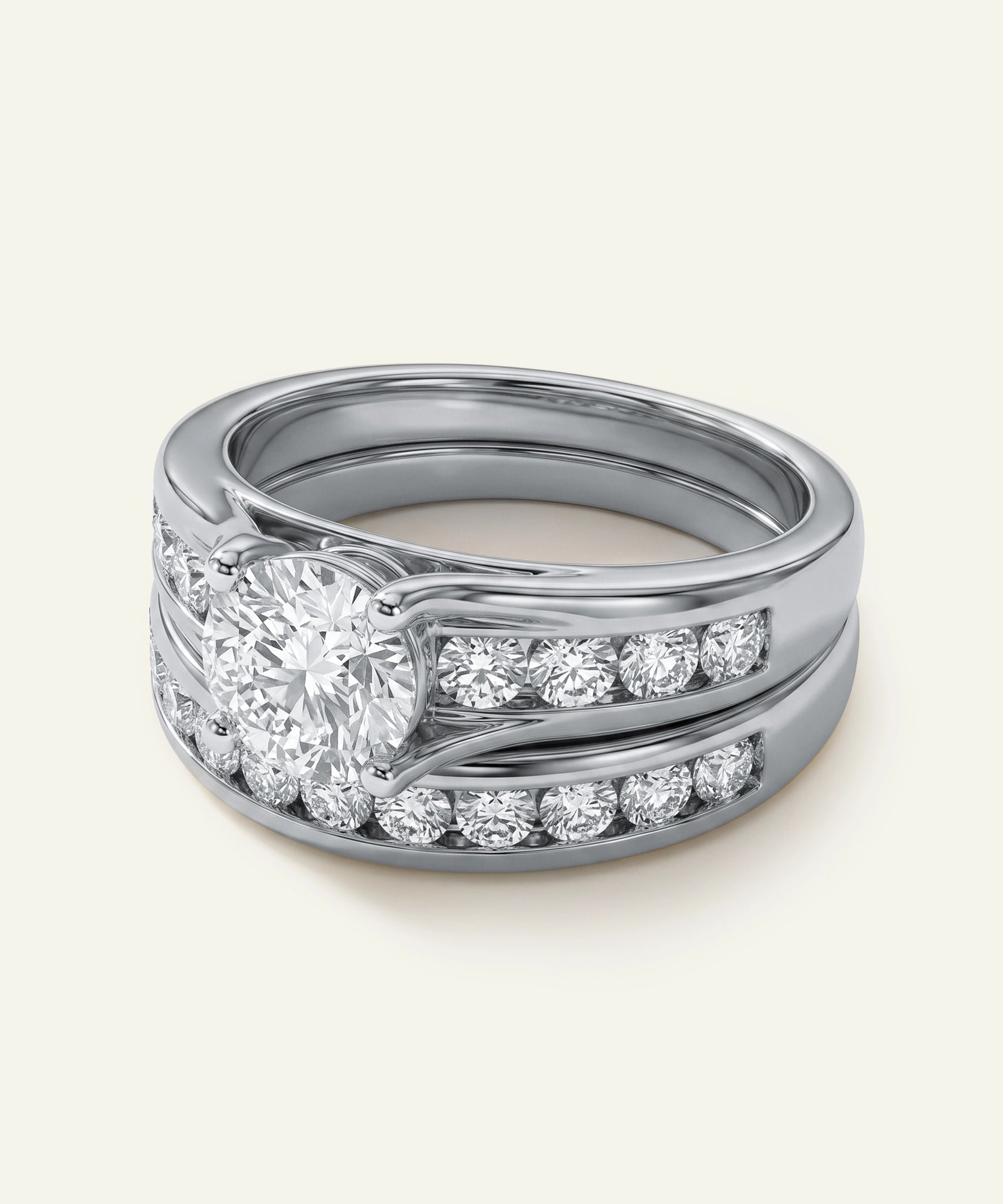 White gold round diamond solitaire engagement ring and channel wedding band set.