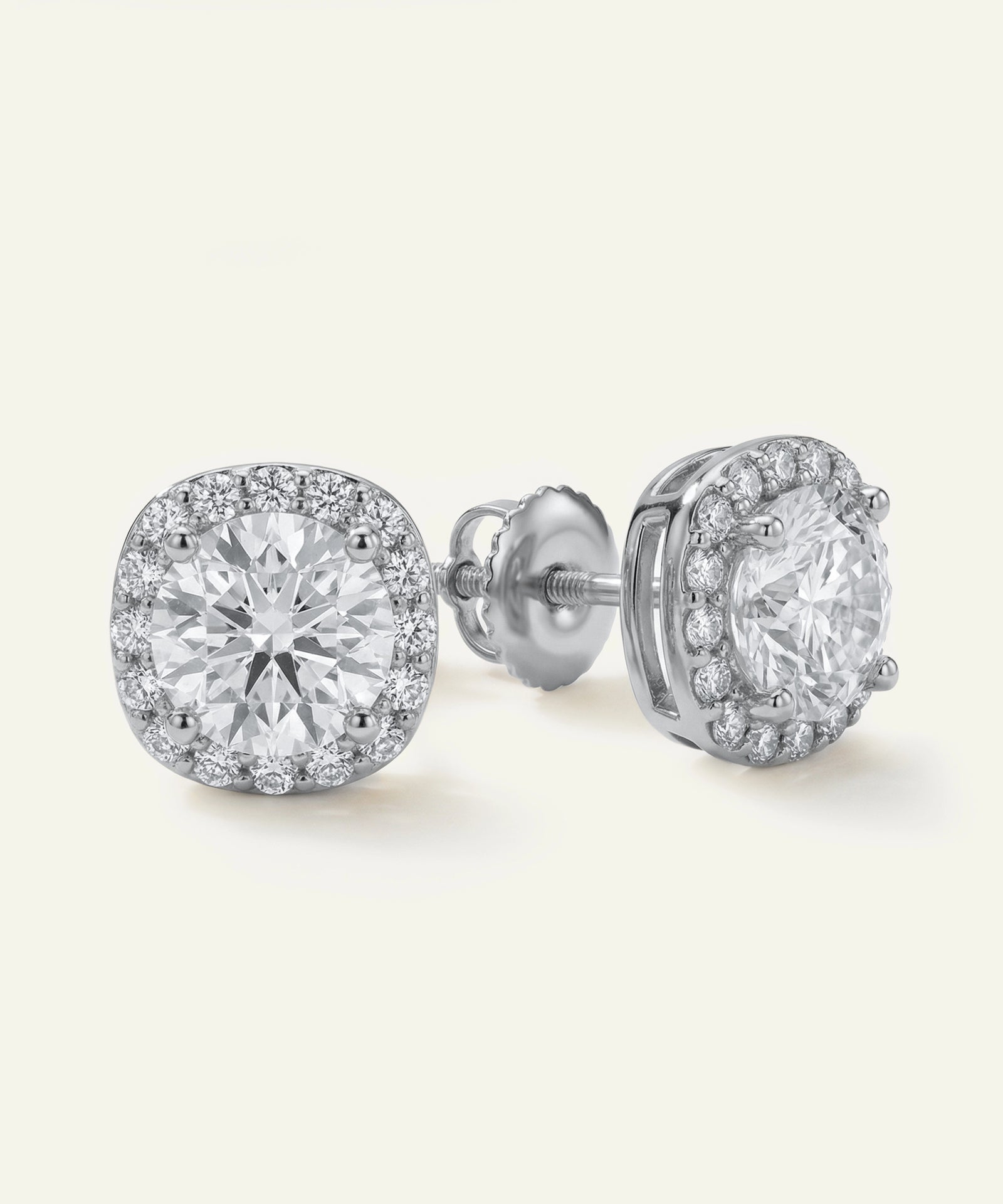 Pair of diamond stud earrings on a white background