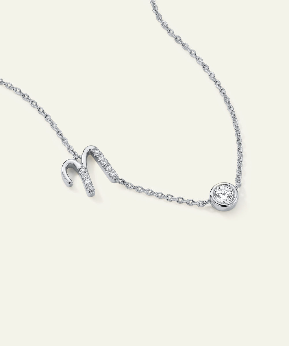 Silver necklace with a small diamond pendant on a white background