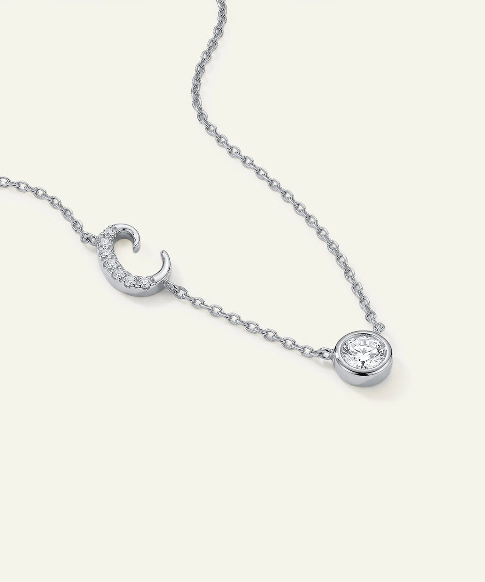 Silver necklace with two diamond pendants on a white background
