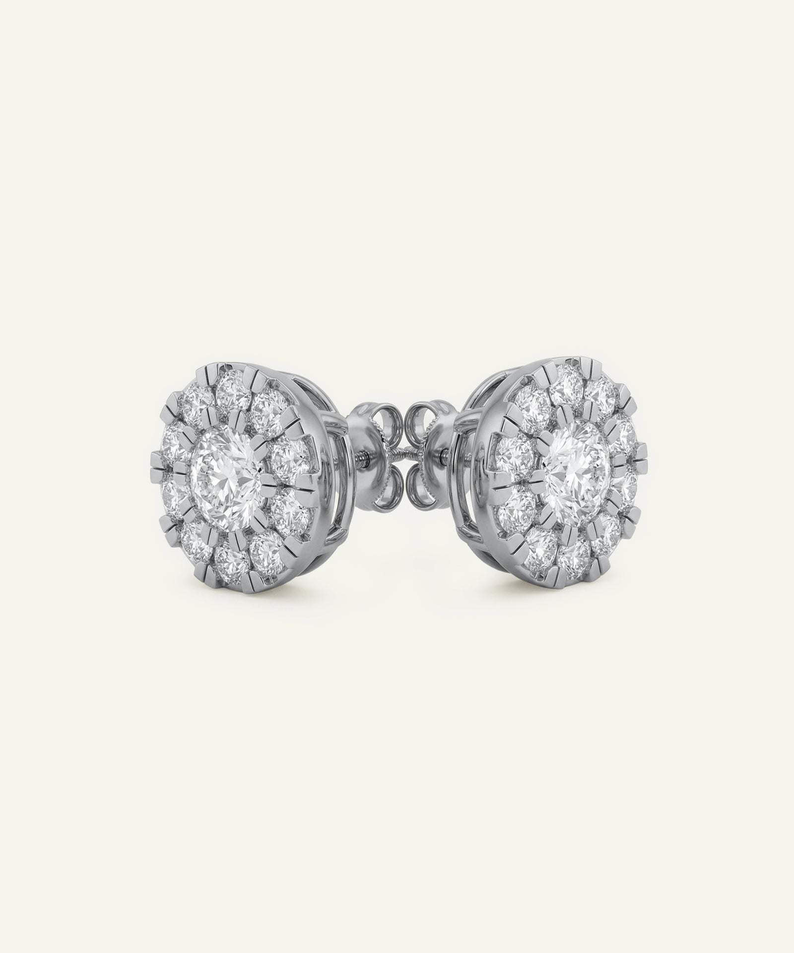 Pair of diamond stud earrings on a light gray background