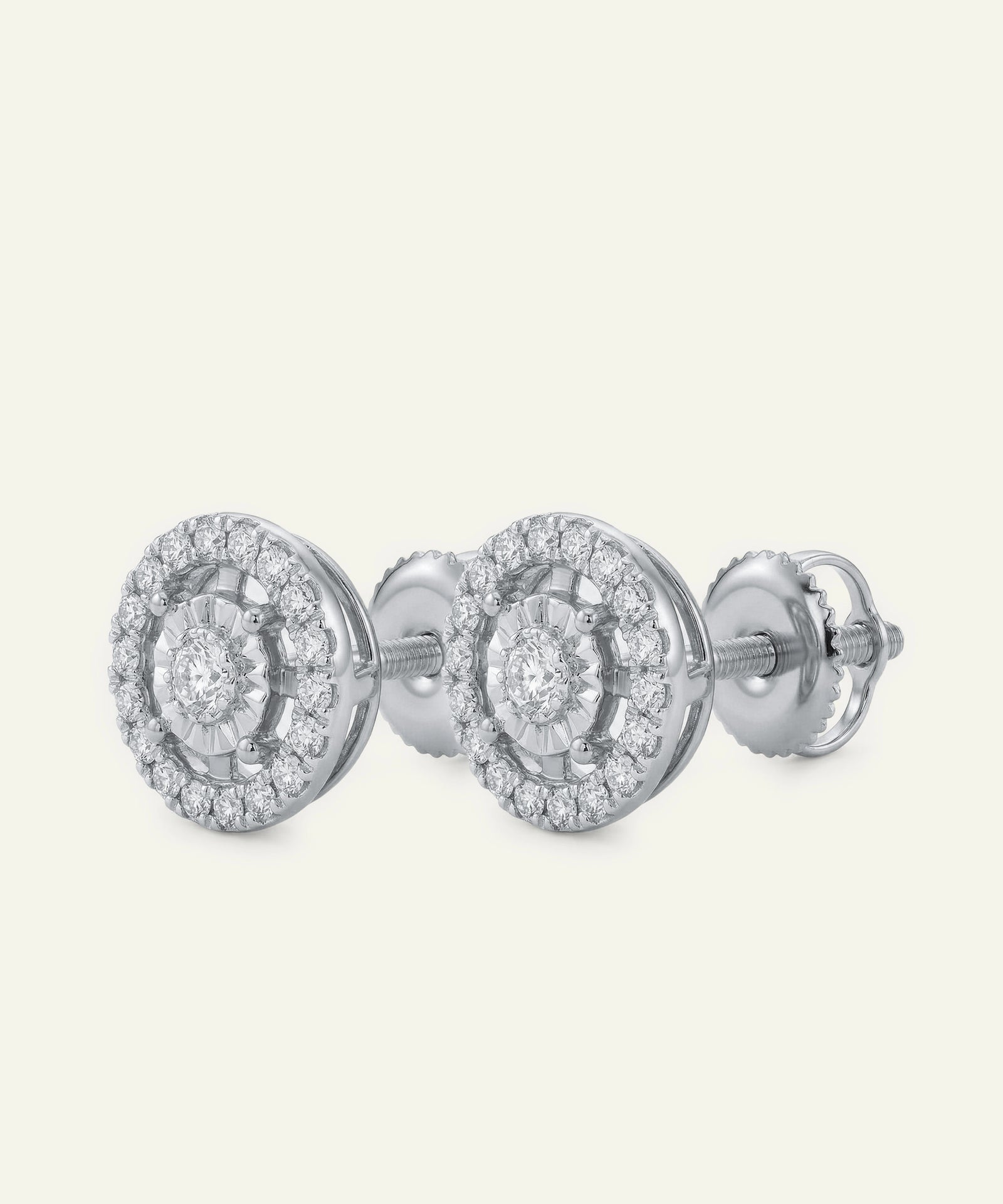 Pair of silver earrings with intricate design on a white background