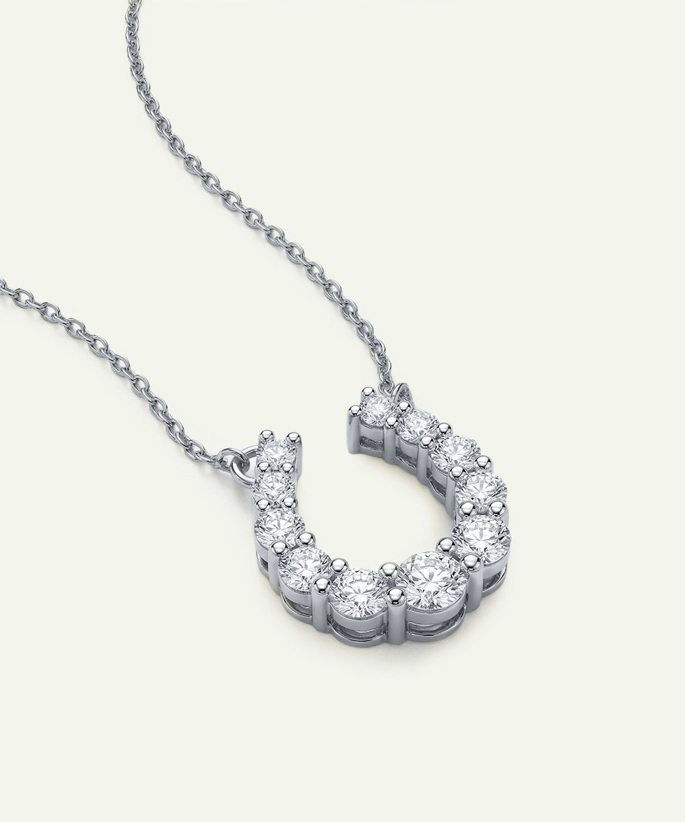 Diamond horseshoe necklace on a white background