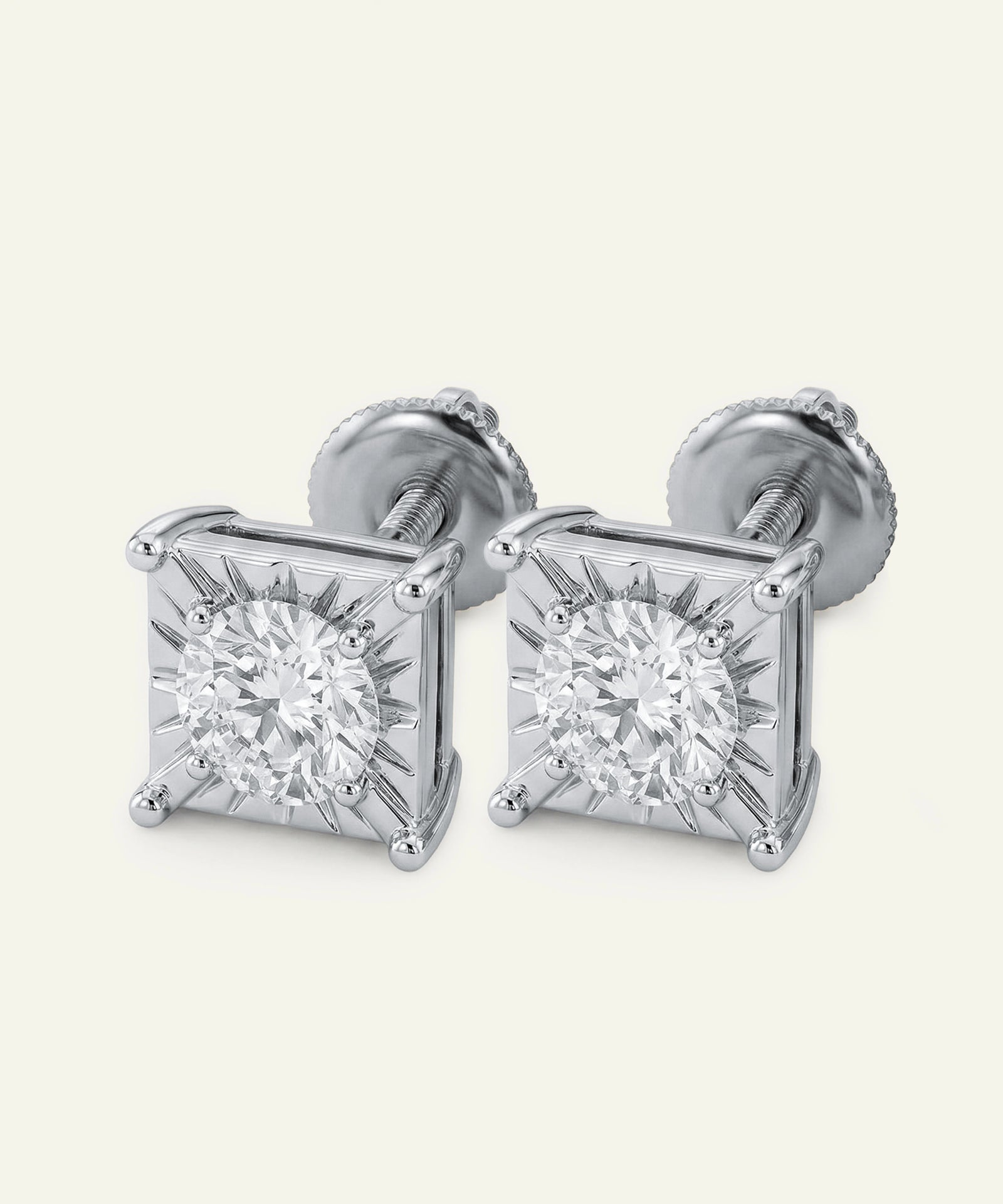 Pair of diamond stud earrings on a white background