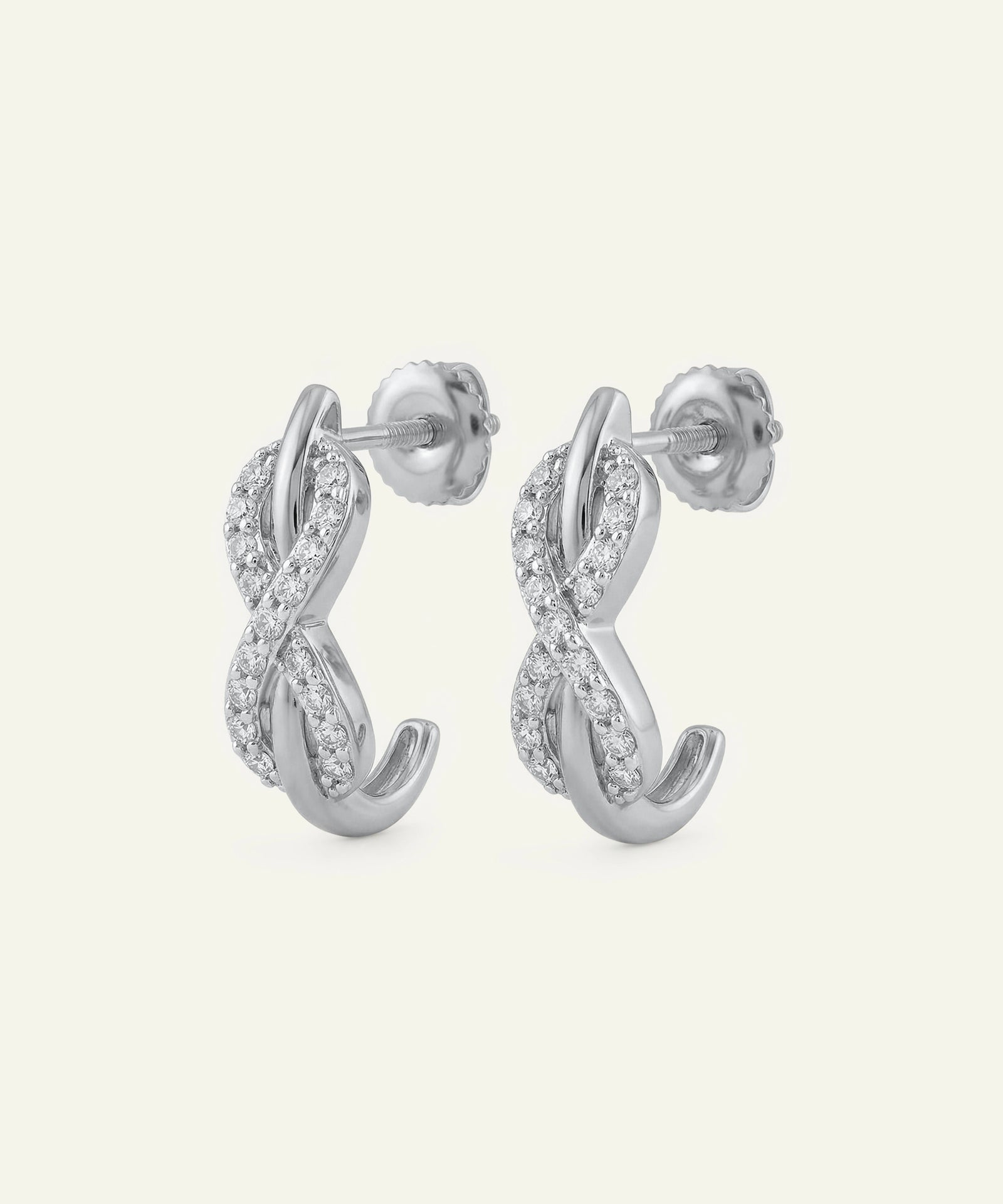 Pair of silver hoop earrings with small diamonds on a white background