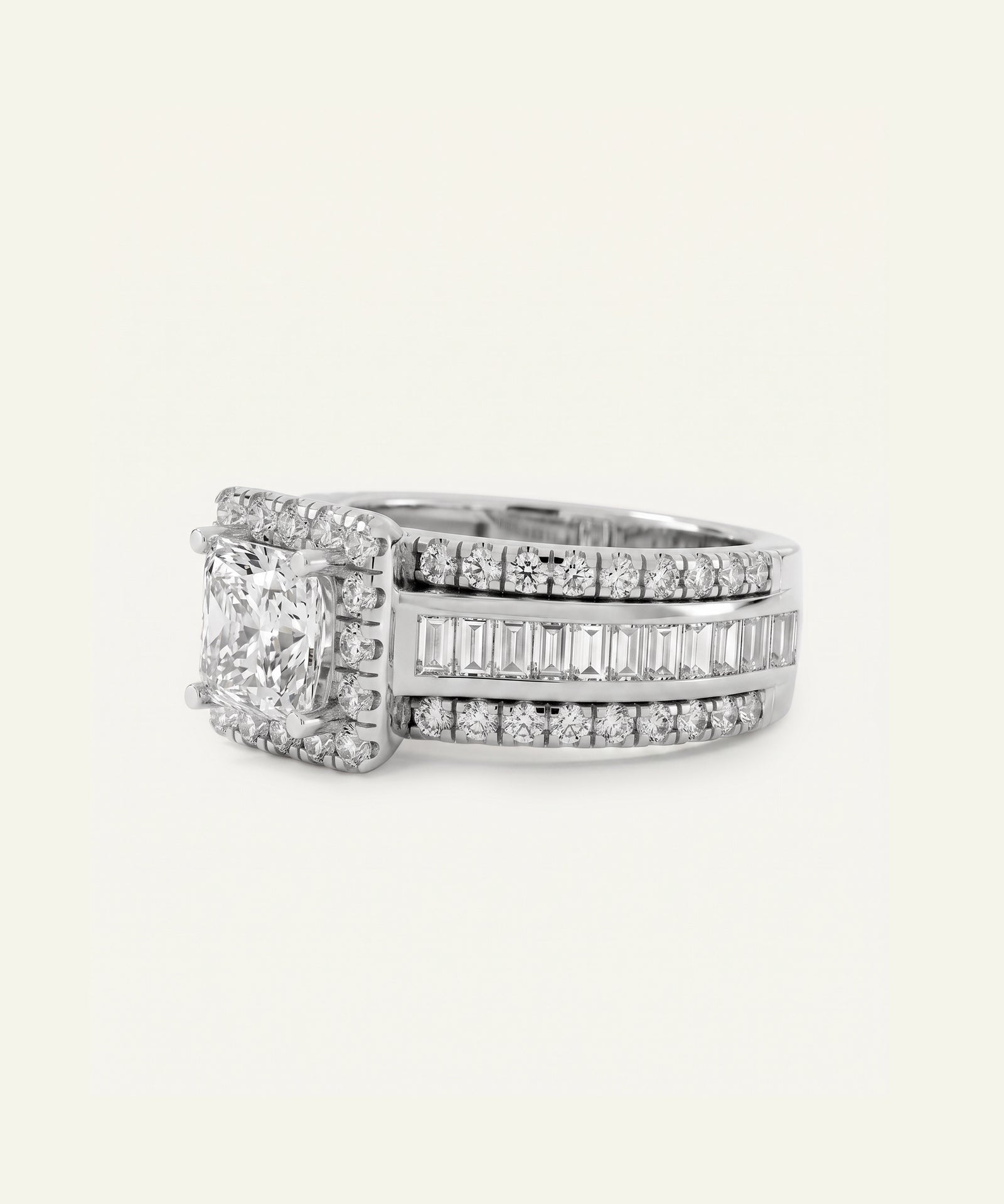A silver-toned diamond ring featuring a large rectangular princess-cut center stone surrounded by a halo, with three rows of channel-set and baguette diamonds on the band, set against a plain off-white background.