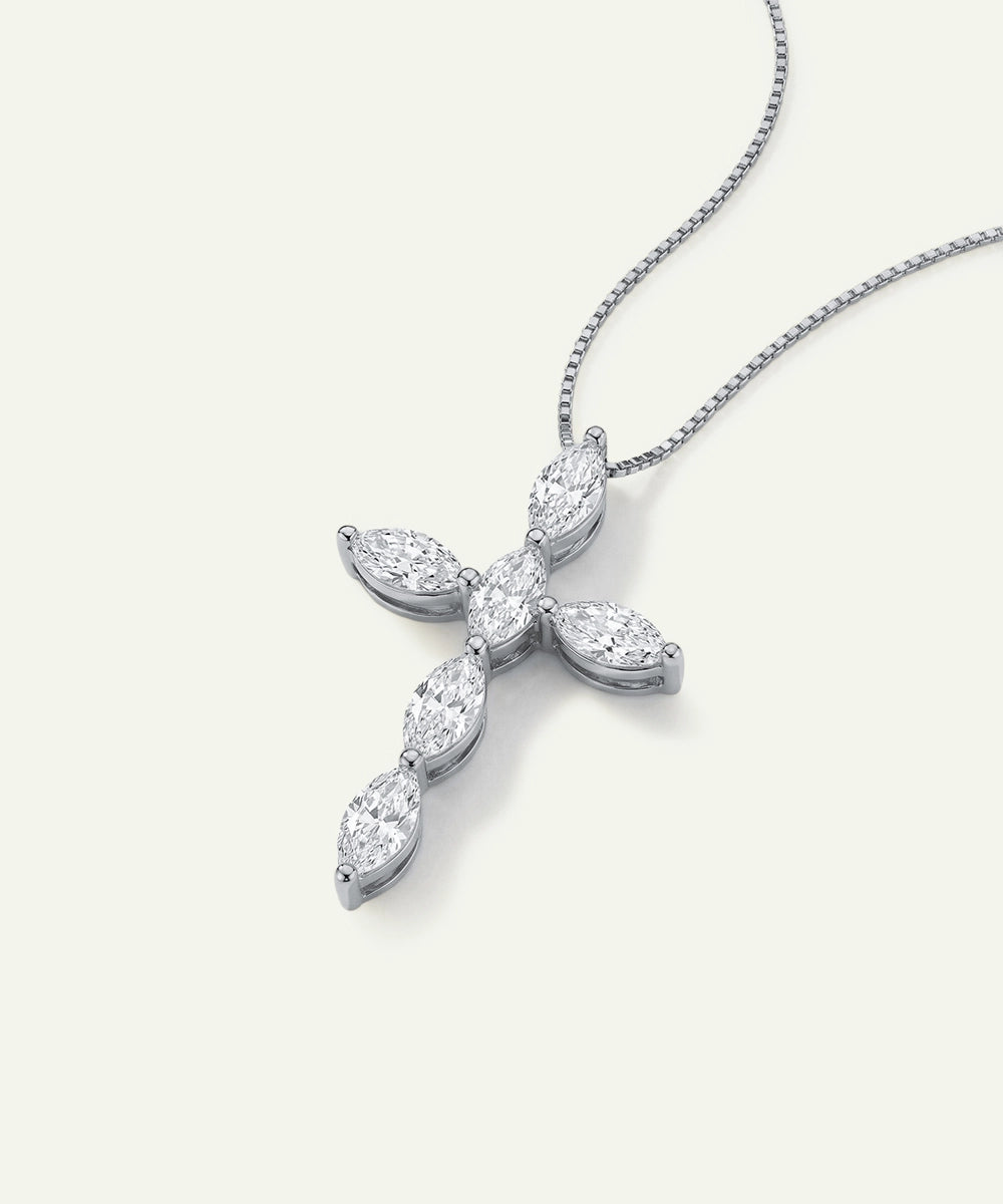 Diamond cross pendant on a white background