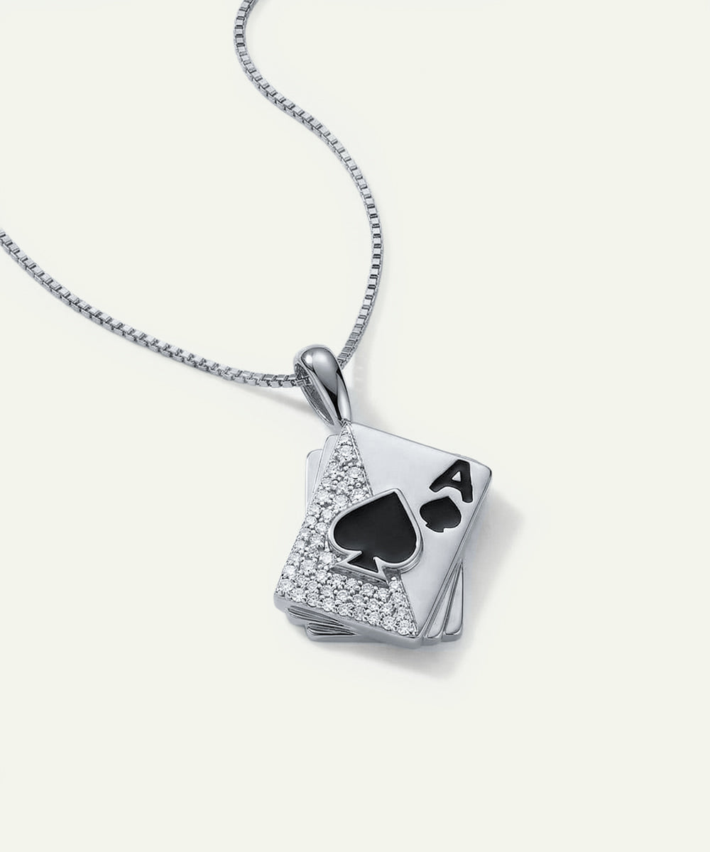 Silver necklace with a card-shaped pendant featuring a spade symbol on a white background