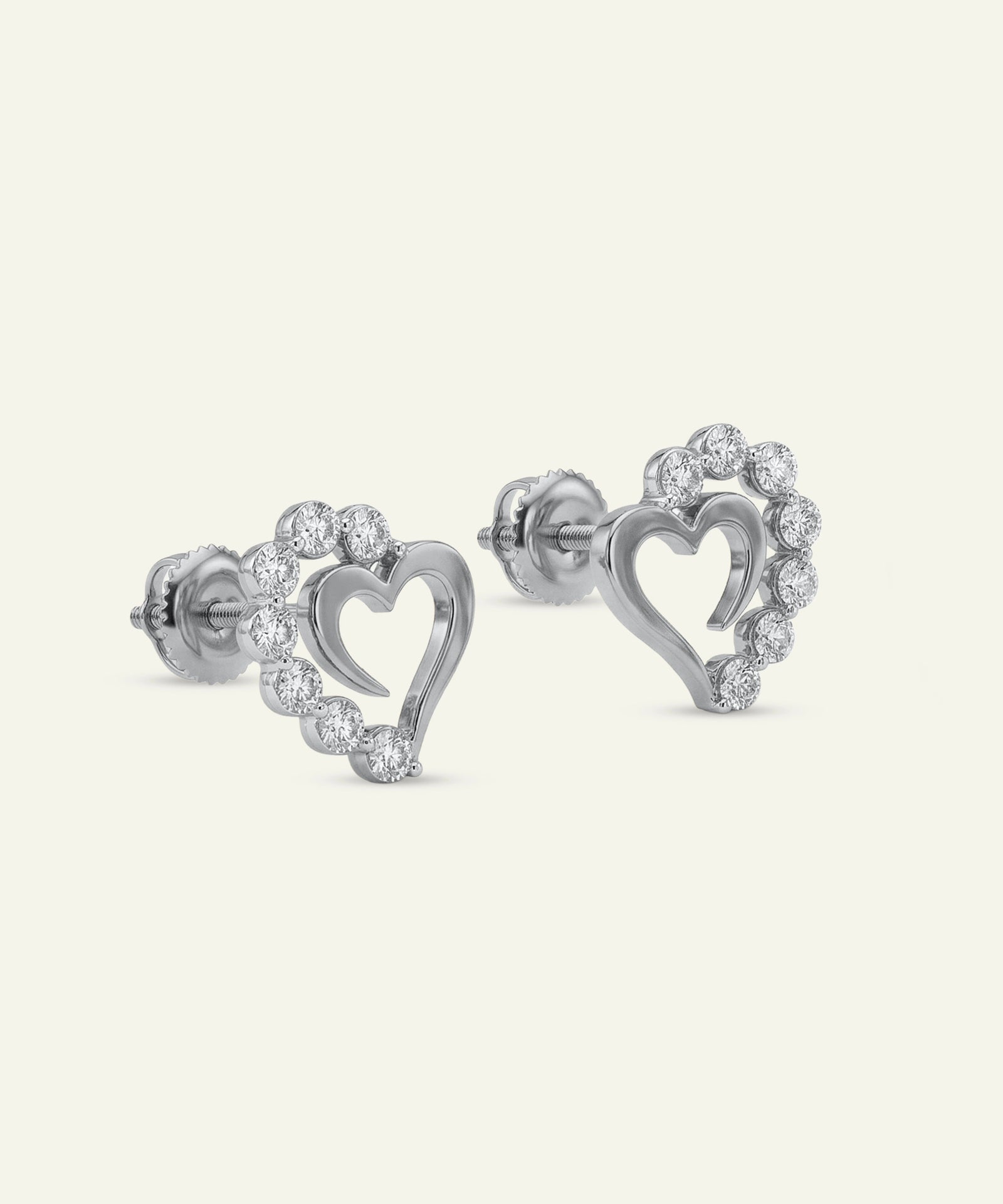 Heart-shaped earrings with clear gemstones on a white background