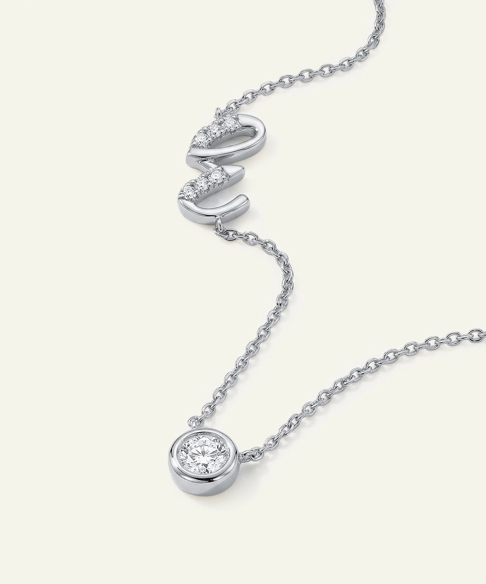 Silver necklace with diamond pendants on a white background