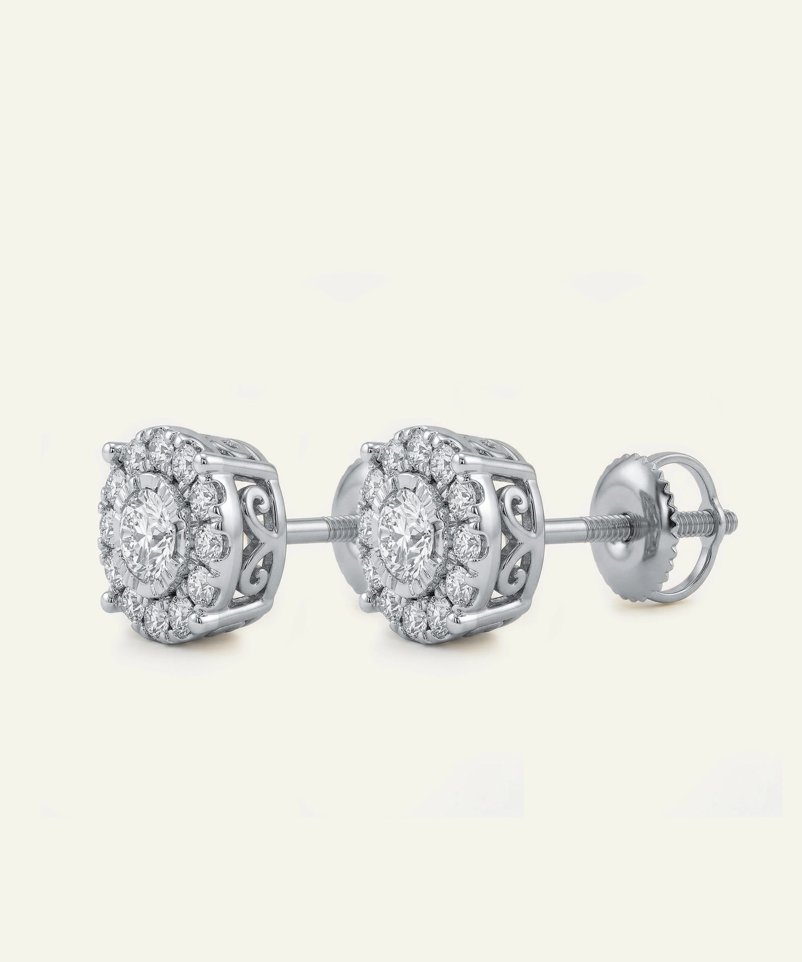 Pair of silver earrings with diamond-like stones on a light gray background