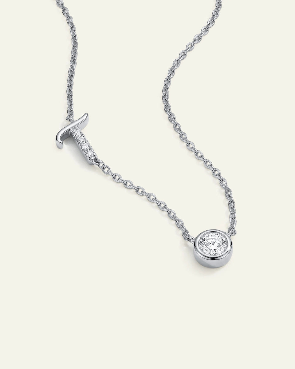 Silver necklace with a round pendant on a white background