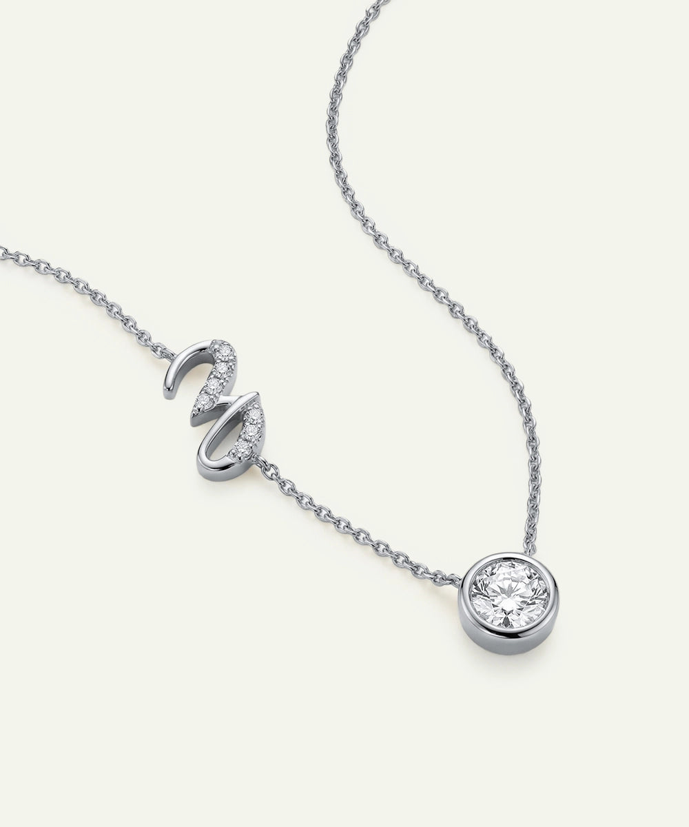 Silver necklace with a round pendant on a white background
