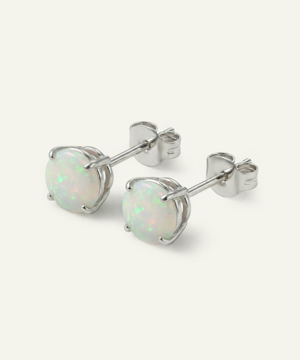 Pair of opal stud earrings on a white background