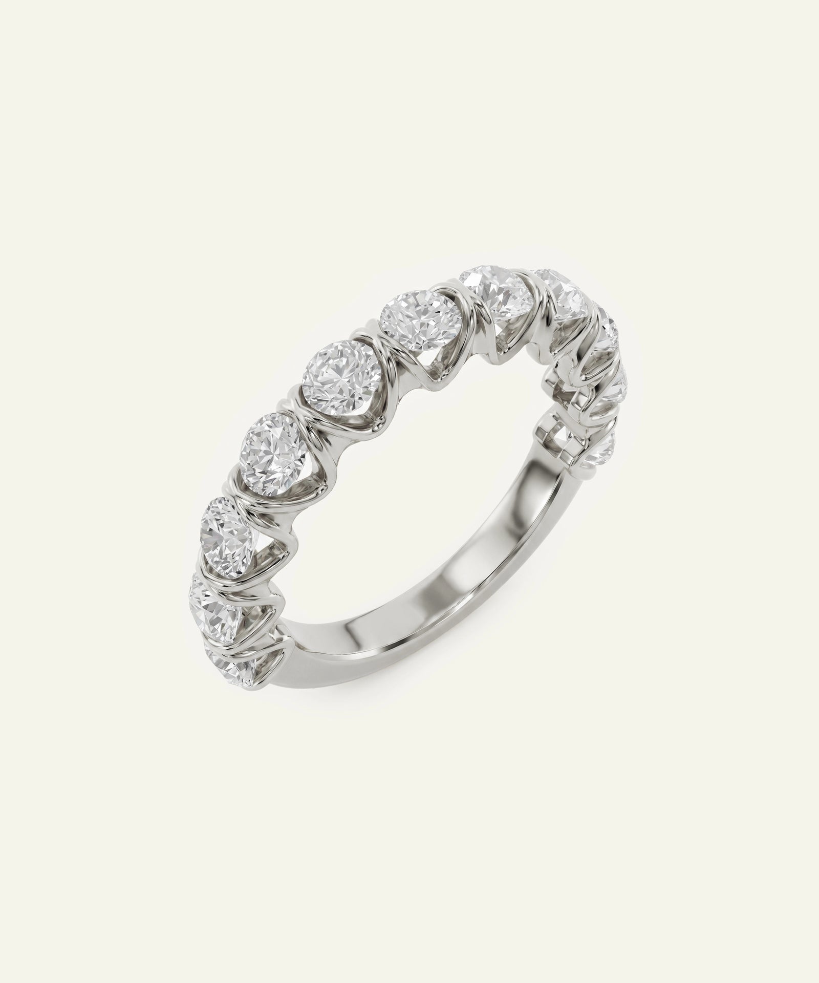 A silver-toned diamond band ring featuring a row of round-cut diamonds set in a textured, organic pattern, shown on a light cream background.