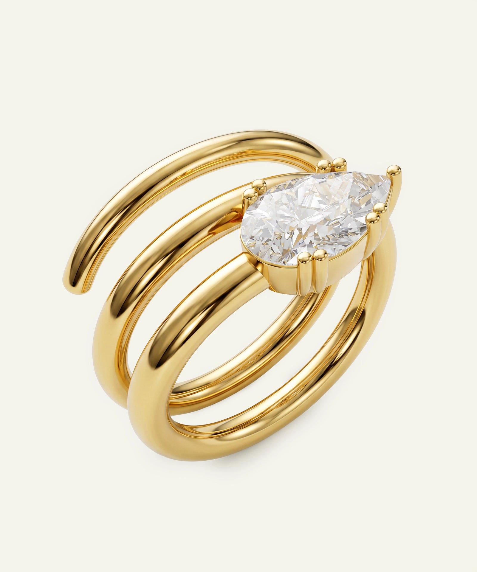 Gold ring with a pear-shaped diamond on a white background