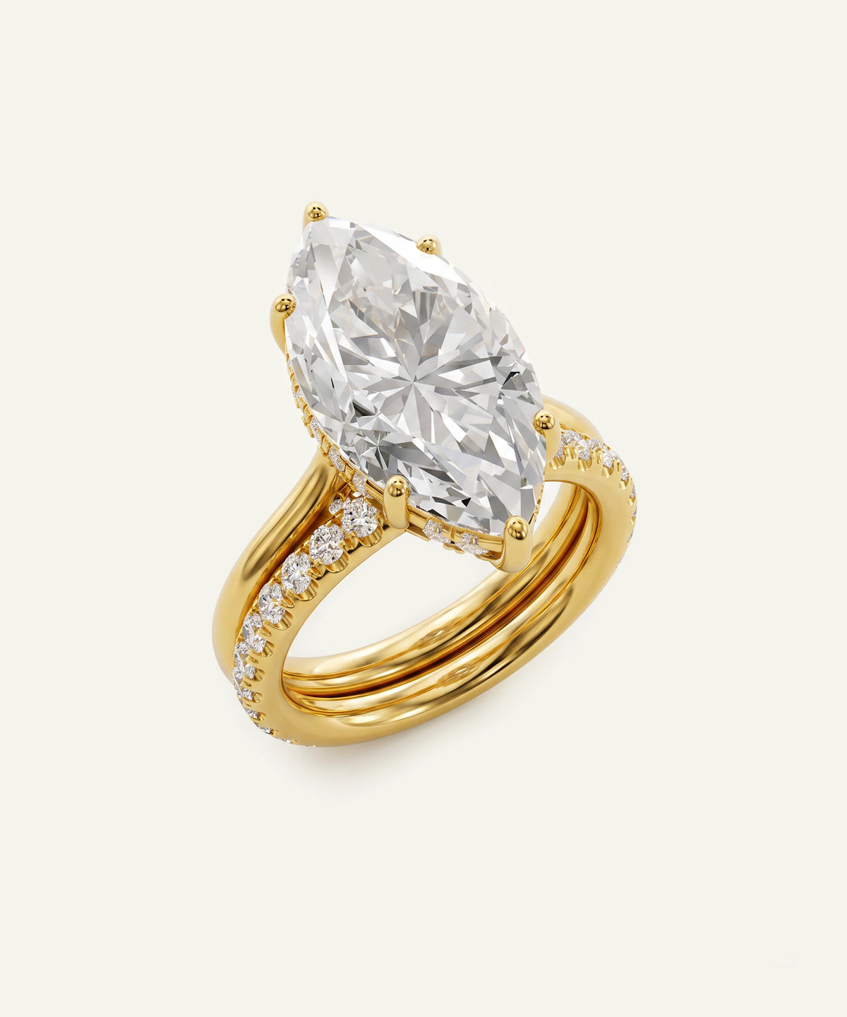 A yellow gold ring featuring a large marquise-cut clear diamond as the center stone, with smaller diamonds set along the split band, shown on a light cream background.