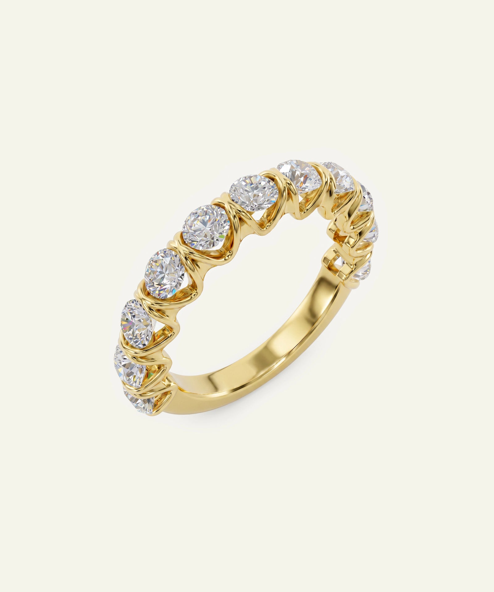 A yellow gold eternity ring featuring a row of round-cut clear gemstones in a prong setting, shown on a light cream background.
