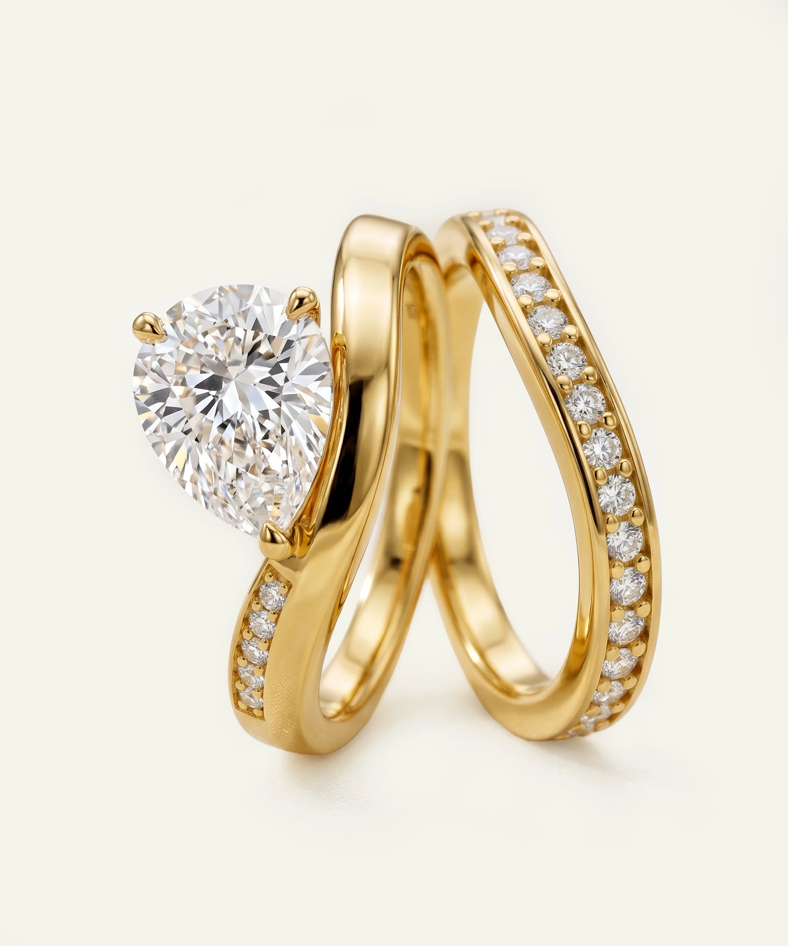 Gold ring with a large diamond and smaller diamonds on a white background
