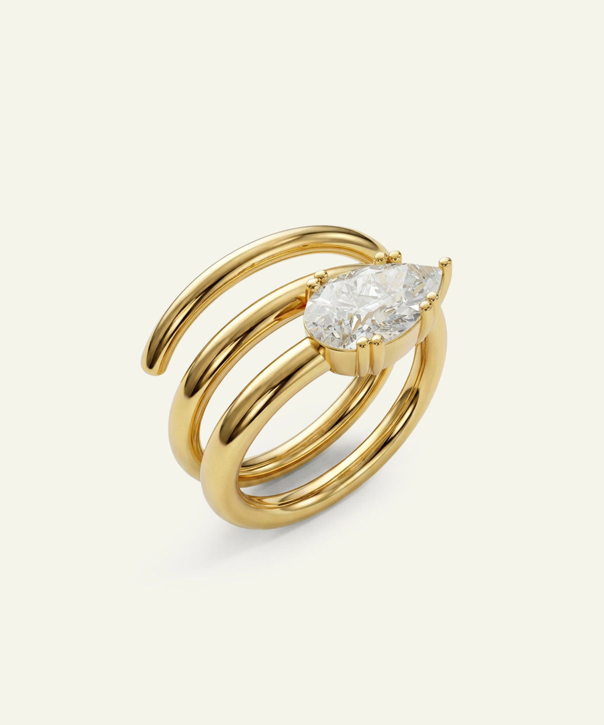 A gold ring with a curved, multi-band design and a large marquise-cut clear gemstone, shown on a light cream background.