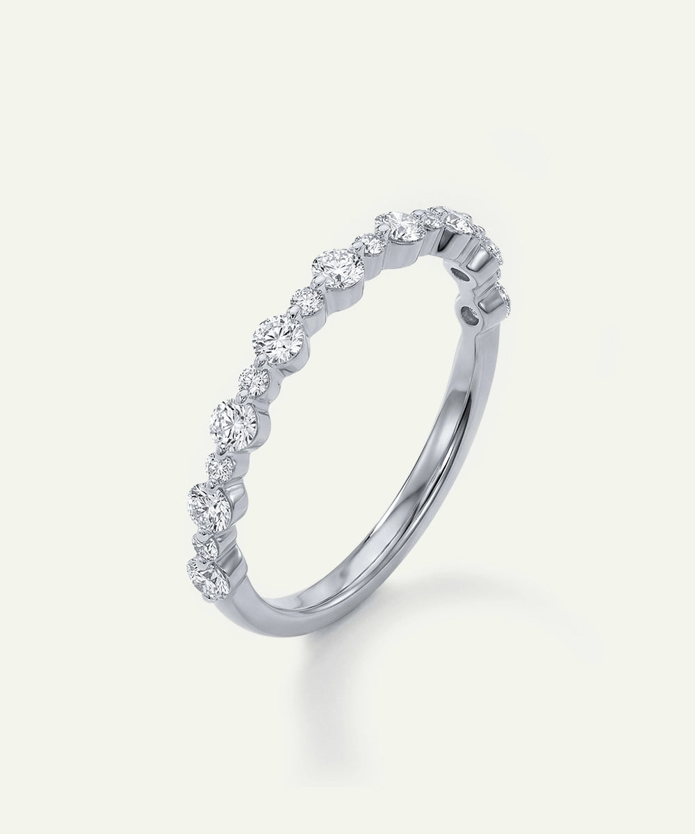 Silver ring with small diamonds on a white background